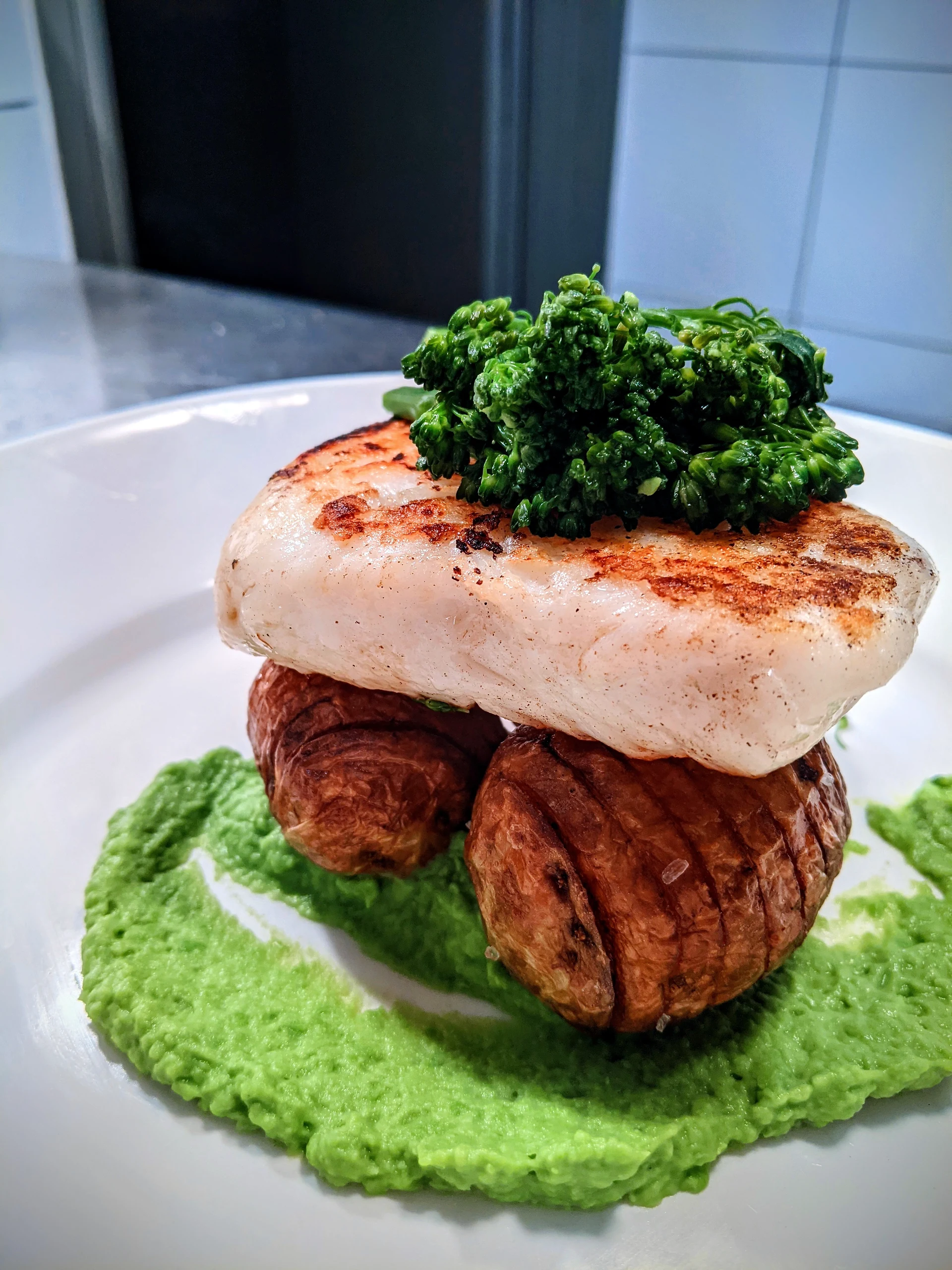 Fish with potatoes, greens and a green purée